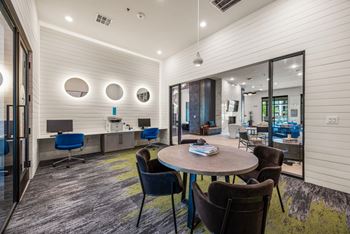 A conference room with a round table and chairs. at The Haywood Apartments, Austin